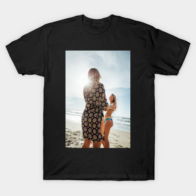 Two Young Pretty Blond Girls Holding Hands and Laughing Together on Sunny Beach T-Shirt by visualspectrum